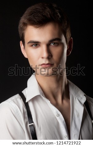 Handsome casual man standing on a black