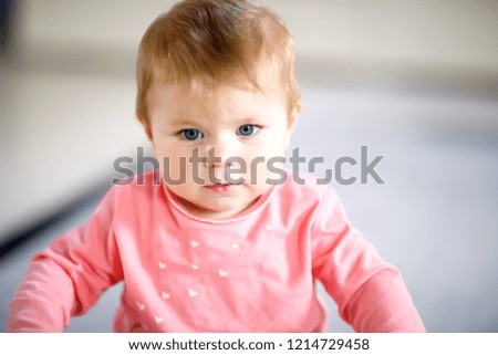 Portrait of cute baby girl at home. Little girl looking at the camera and smiling. Family, new life, childhood, beginning concept