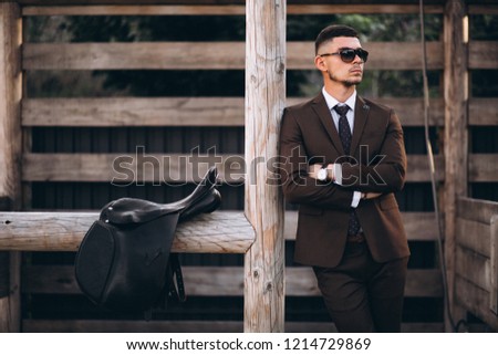 Handsome man in suit at ranch