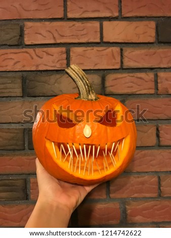 Halloween pumpkin with hand
