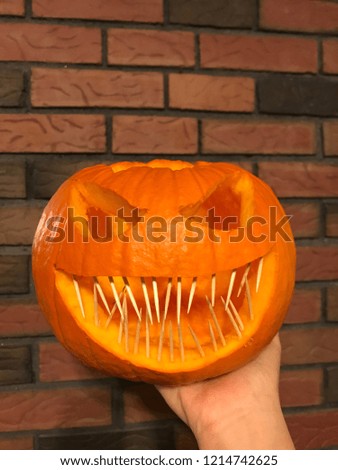 Halloween pumpkin with hand
