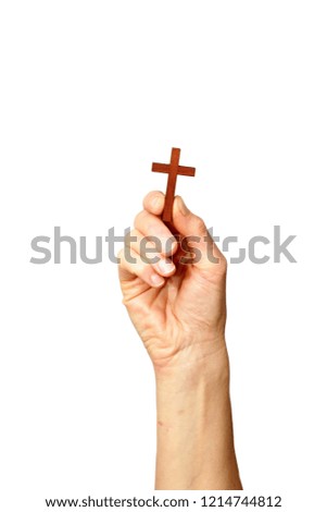 Hand holding a cross up high