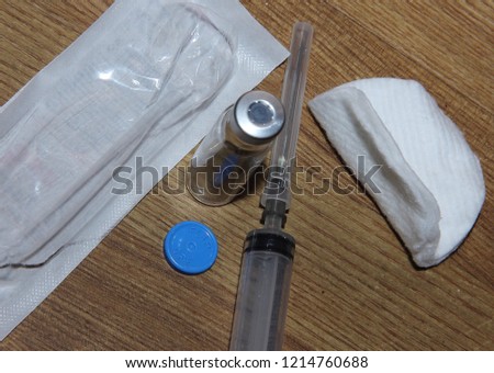 the composition is a syringe, a vial of medication, the sponge, the packaging of the syringe
