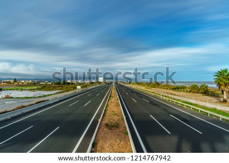 Wide angle ultra long exposure of freeway with clouds