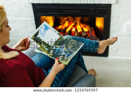 High angle view of young girl looking through photo album at home