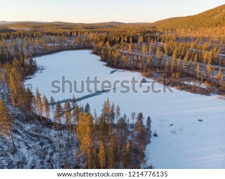 Drone shot of a frozen lake in autumn in Swedish Lapland