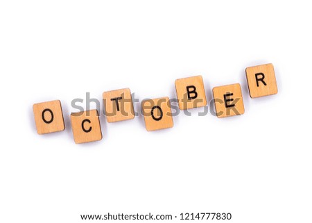 OCTOBER, spelt with wooden letter tiles over a plain white background. 