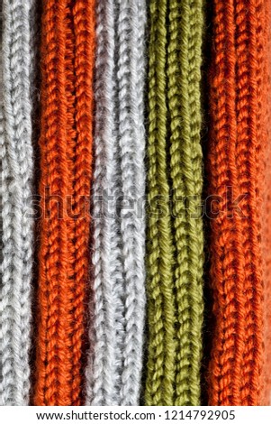 Orange, green and grey wool knitted texture background.