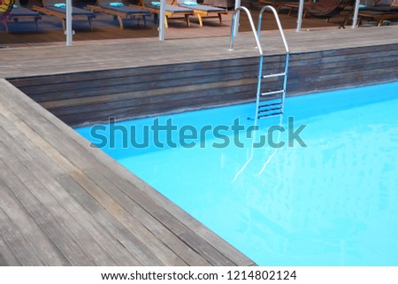 swimming pool with water and wooden walkways