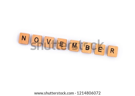 NOVEMBER, spelt with wooden letter tiles over a plain white background. 