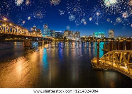 Downtown Portland celebrating New Years Eve with colorful fireworks in the sky above Wilamette river, in Oregon, USA