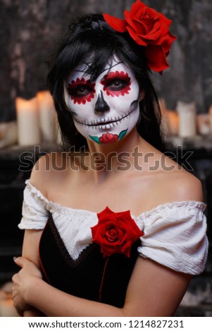 Portrait of zombie woman with grim bodypainting on face