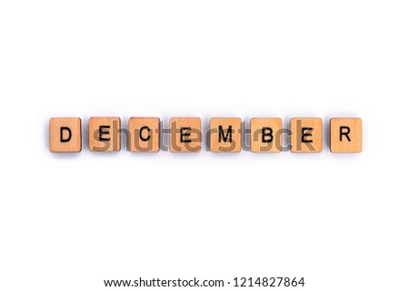DECEMBER, spelt with wooden letter tiles over a plain white background. 