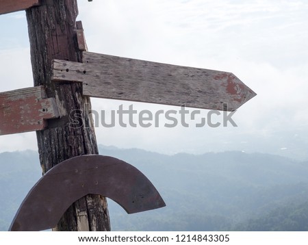 Three old wooden signboard arrow template the background is a mountain. wooden signboard arrow is blank for insert content and text