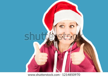 Attractive smiling young girl dressed in Santa's hat listening the music by headphones. Christmas and New Year advertising concept. Magazine style fashion collage