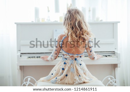 beautiful girl plays a piano