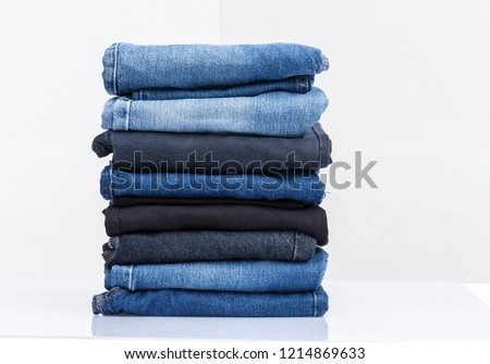 
Jeans trousers stack on white background Royalty-Free Stock Photo #1214869633