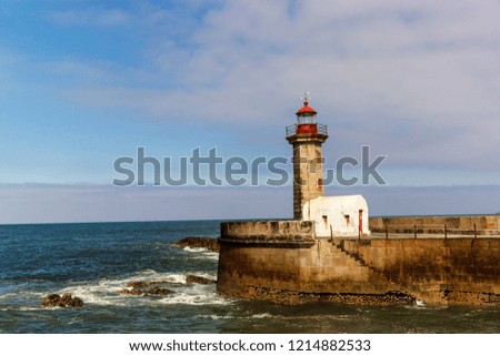 Lighthouse at the mouth of the river Douro in Porto, Portugal in calm. Atlantic ocean. Travel photography.