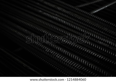 closeup of hard rods division rebars, used on stacked construction concrete background. industrial professional equipment pattern, stiff macro perspective image for reinforcement and construction
