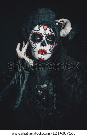 Portrait of Calavera Catrina in darkness. Sugar skull makeup. Dia de los muertos. Day of The Dead. Halloween.