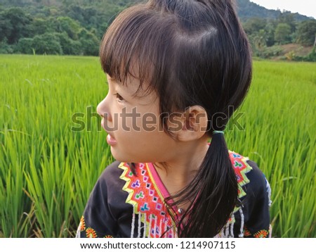 
Pictures from the back of a girl looking in a green field