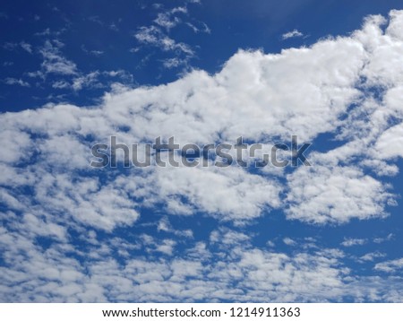 Blue sky with the row of clouds in a sunny day.