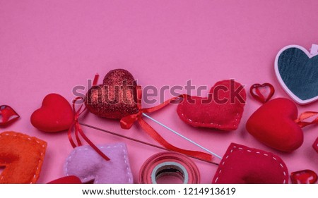 Table top view aerial image of decoration valentine's day background concept. Flat lay essential items red heart and gift box on pink paper.