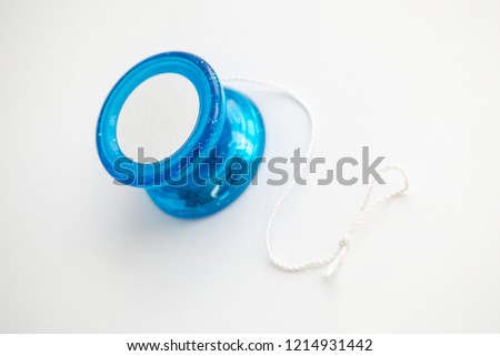 Blue yo-yo yo yo toy with a knotted string on a white background