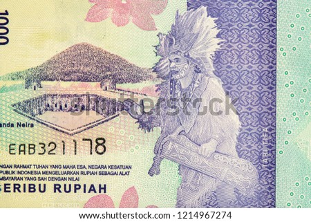 Indigenous people in a drum set (Tari Tifa). Portrait from Indonesia 1000 Rupiah 2016 Banknotes.