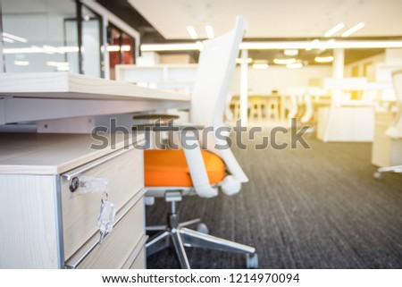 Open space office of a modern company,carpet and rows of wooden computer tables