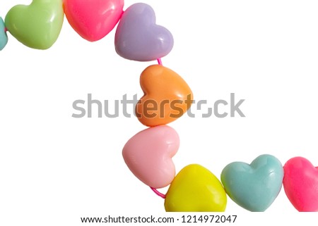 Photo frame from plastic hearts of different colors on a white background