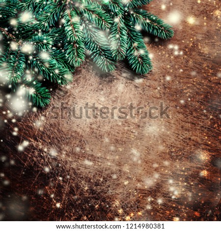 Christmas background with festive decoration, pine tree branch, snowflakes and bokeh lights on  dark wooden board.  Merry Christmas and Happy New Year Concept. Copy space. Flat lay.
