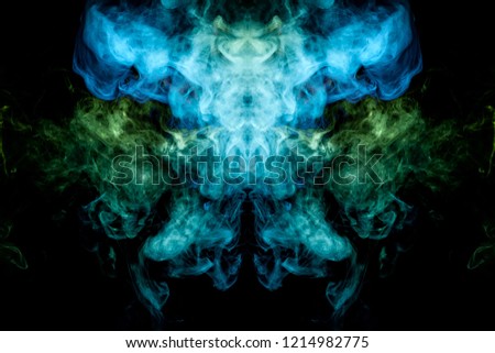 
Thick colorful green and blue  smoke  in the form of a skull, monster, dragon on a black isolated background. Background from the smoke of vape. Mocap for cool t-shirts