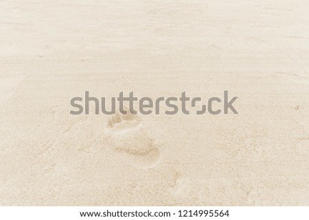 close up of footprints in the sand on the beach