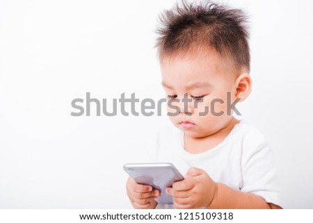 Asian portrait child boys 1 year 6 months holding smartphone on hand on white background