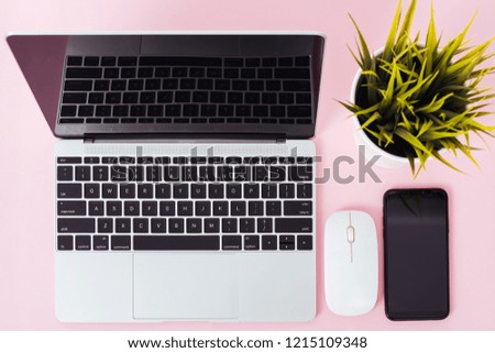 Top view of modern technology smart phone mobile and computer laptop on pink background with copy space