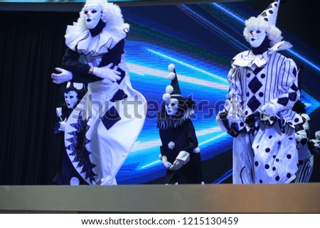 Creepy Scary Mask custome dancer perform on a stage. Creepy Performance for Holloween. Selected Focus