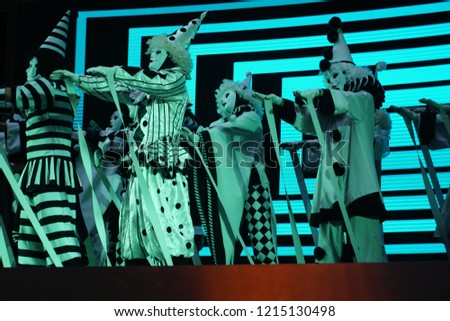Dancer wearing a creepy scary white mask and costume performing on stage for hallowen festival. Hallowen Concept. Selected FOcus