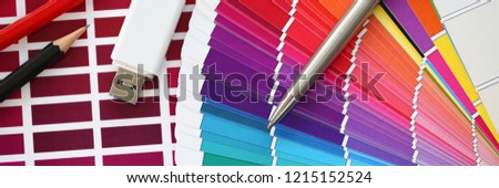 Stationery and USB flash drive on design background. Color print of pantone statistics offset organization gives customer an order products for distribution during promotion concept