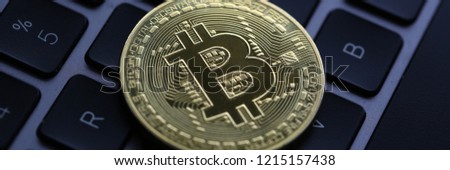 Coin crypto currency bitcoin lies on the keyboard background theme of the gold exchange pyramid for money due to the rise or fall of the exchange rate