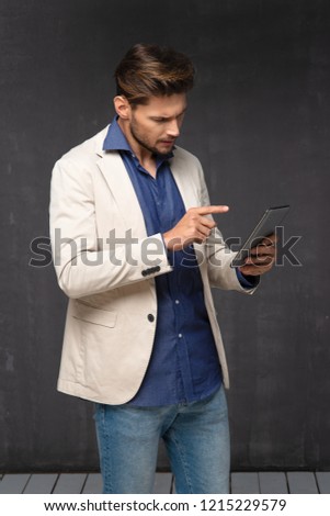 Happy handsome man with tablet