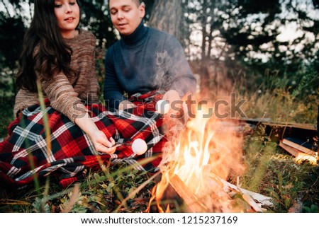 Summer Camp Fire.Couple in love. Camping fire. Love story. Romance lovers. Fashion photo.