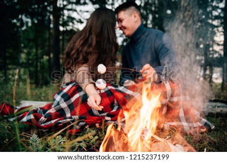 Summer Camp Fire.Couple in love. Camping fire. Love story. Romance lovers. Fashion photo.