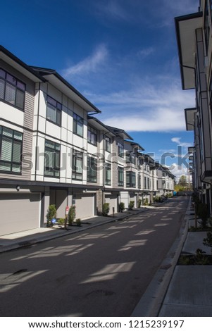 A row of a new townhouses. External facade of a row of colorful modern urban townhouses.brand new houses just after construction on real estate market