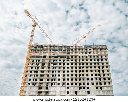 Building of multiroom inhabited highly floor house. Cranes on a construction site