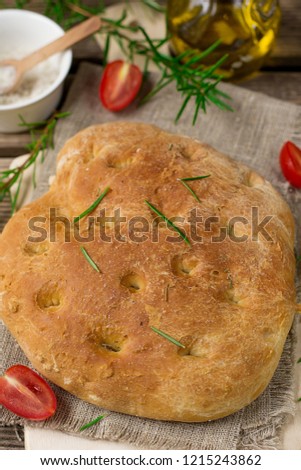Flat oven-baked Italian bread Focaccia with rosemary and sea salt