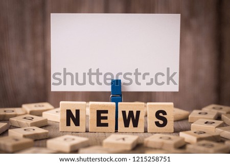 News Concept with old wooden background.