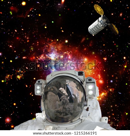 Astronaut posing against galaxies and stars. Outer space. The elements of this image furnished by NASA.