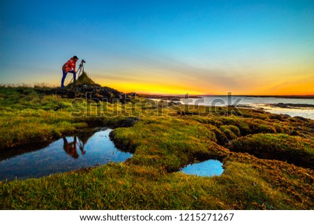 A photographer taking a picture of amazing landscape of Iceland