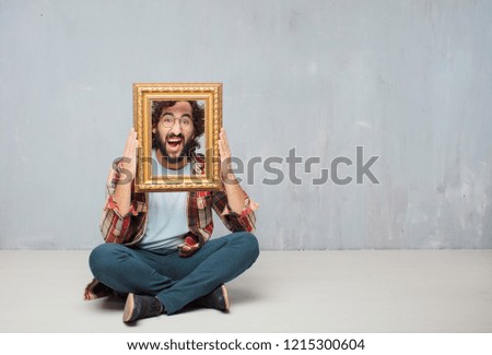 young crazy mad man  fool pose holding a baroque frame
